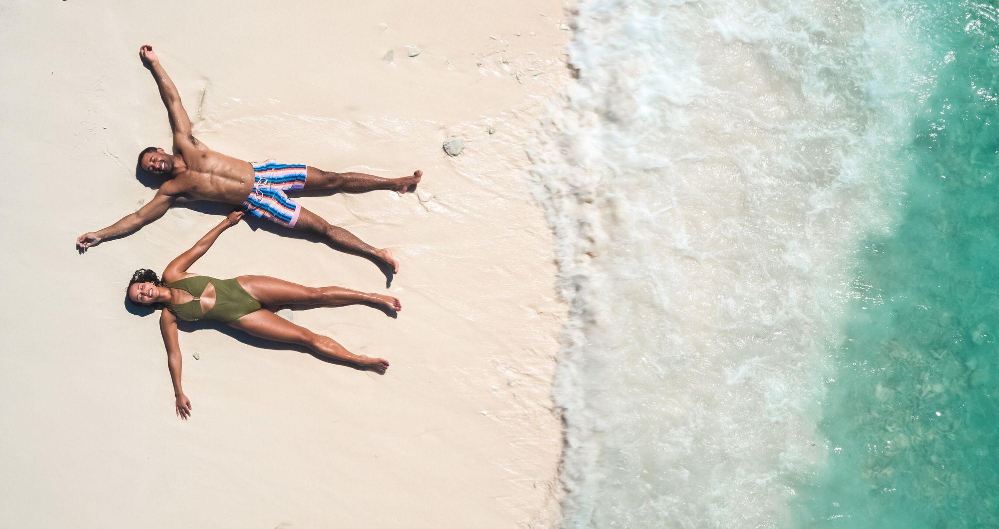 Web-Version-SCR-Lifestyle-Birdseye-view-Couple-Laying-Sand-2
